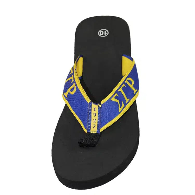 Black sandal with blue and yellow strap on a white background