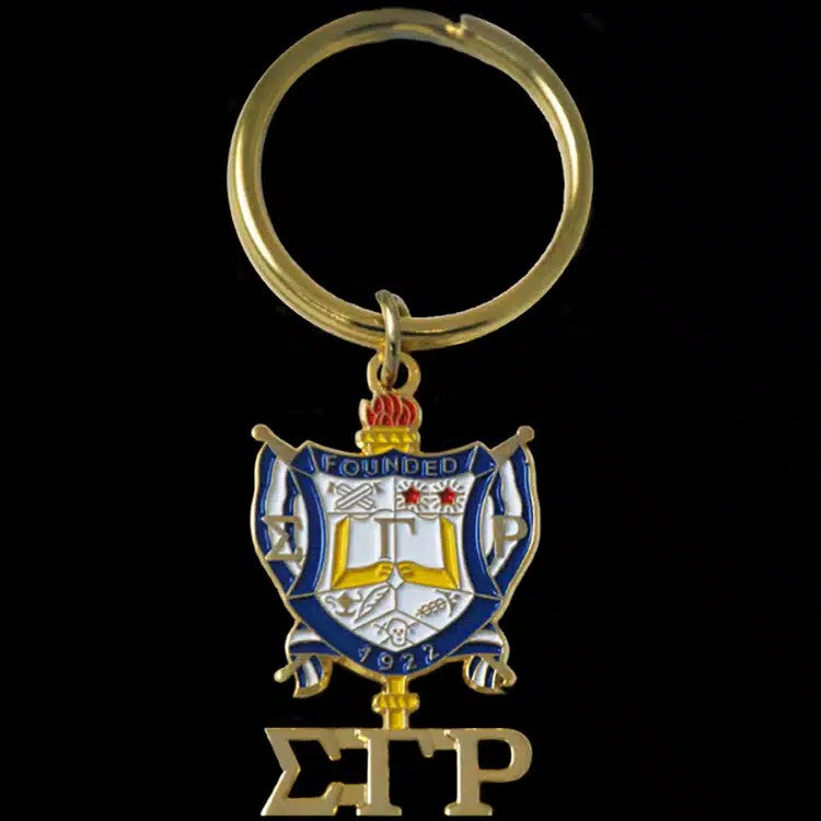 Keychain with a crest and letters 'S' and 'P' on a black background