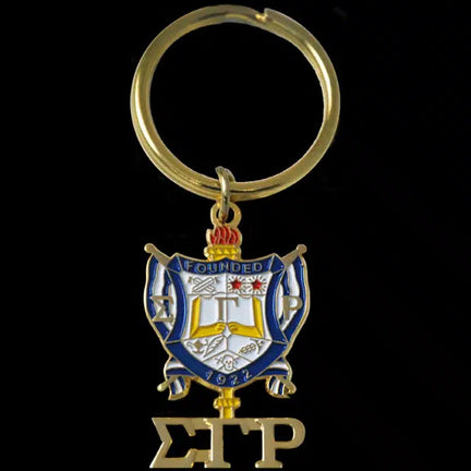 Keychain with a crest and letters 'S' and 'P' on a black background