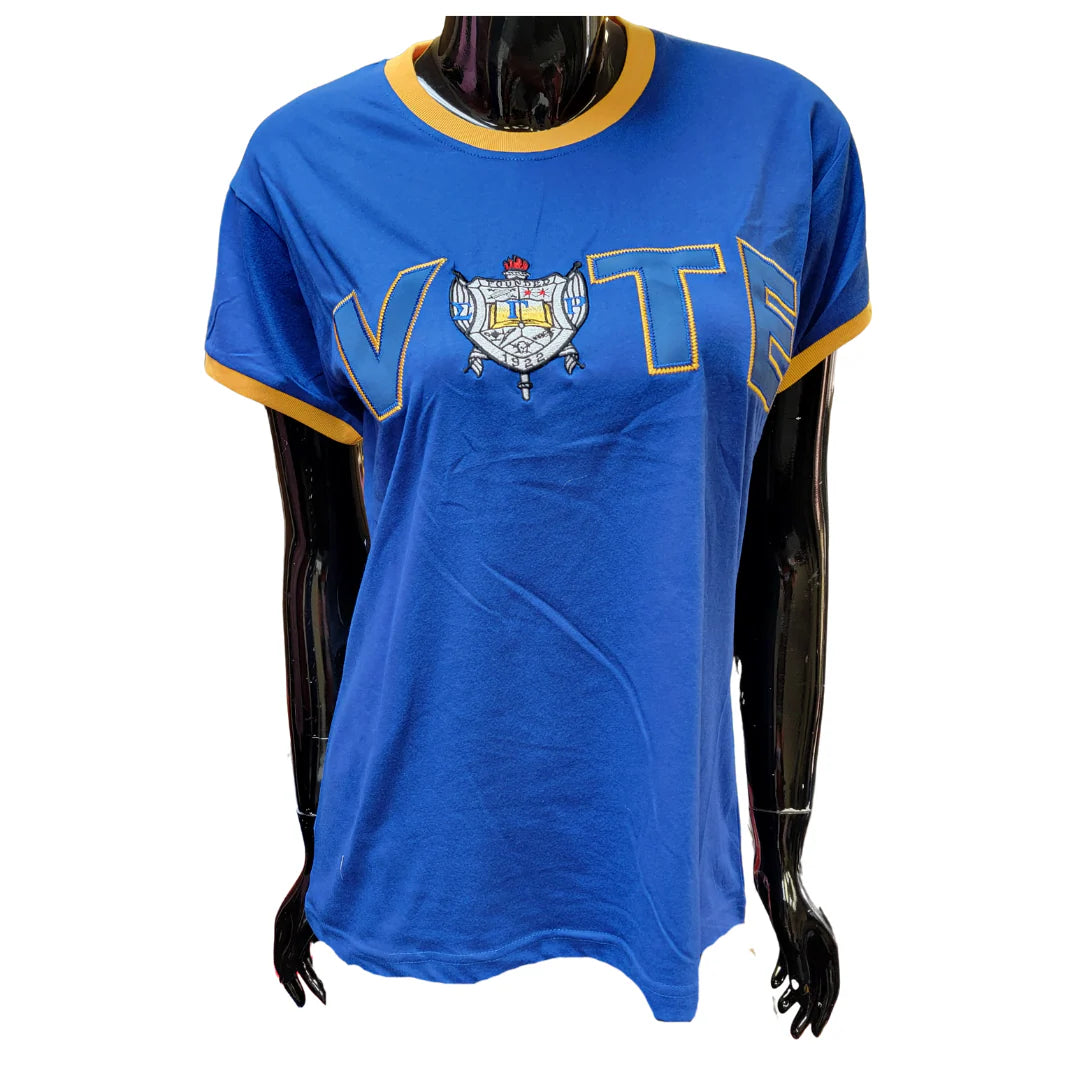 Blue t-shirt with a crest design on a mannequin against a white background