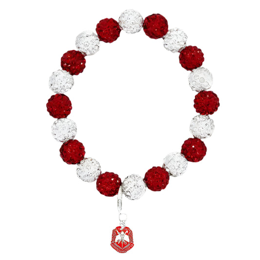 Bracelet with red and white beads and a heart-shaped charm on a black background