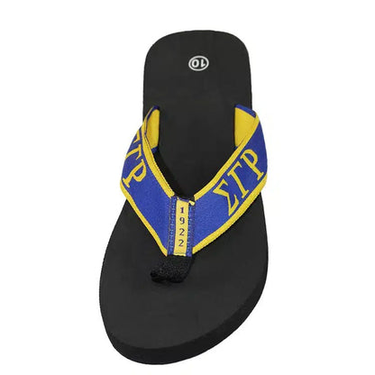 Black sandal with blue and yellow strap on a white background