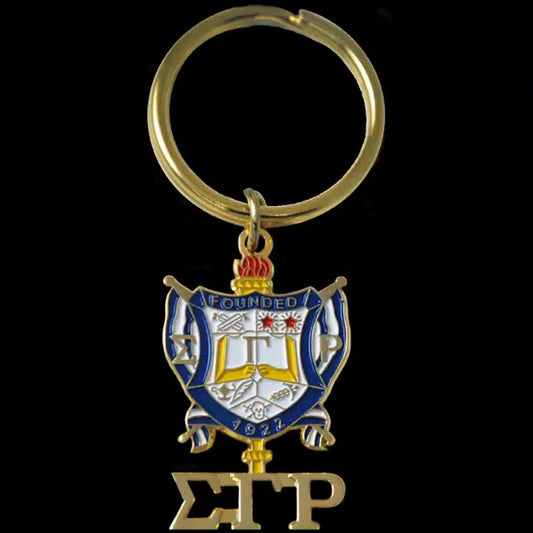 Keychain with a crest and letters 'S' and 'P' on a black background